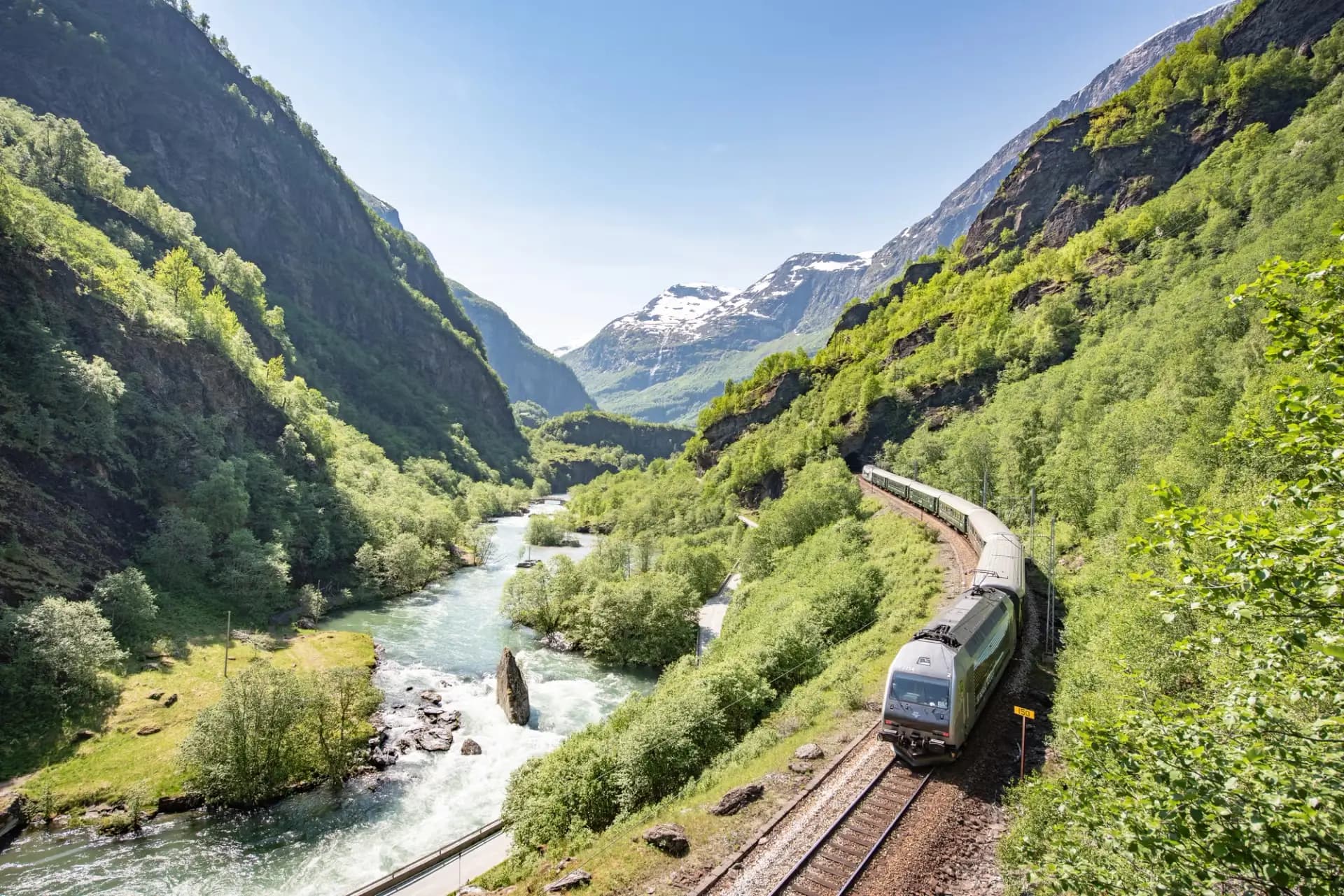 Toget på Flåmsbana køyrer forbi elva